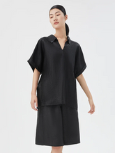 a lady in xiang yun silk bermuda shorts with matching shirt